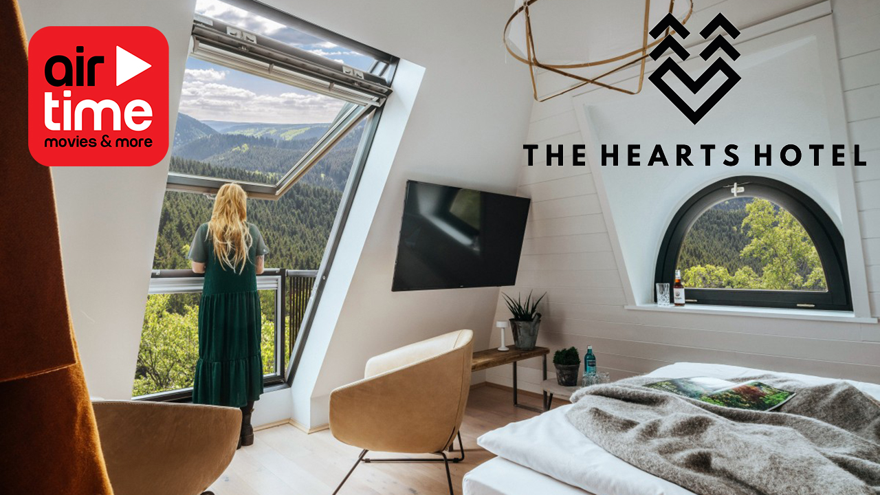 Hearts Hotel News image of woman looking out of a hotel window with hotel entertainment