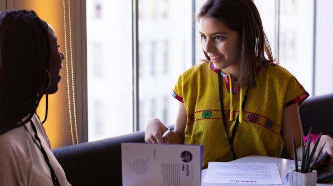 Two students discussing an idea