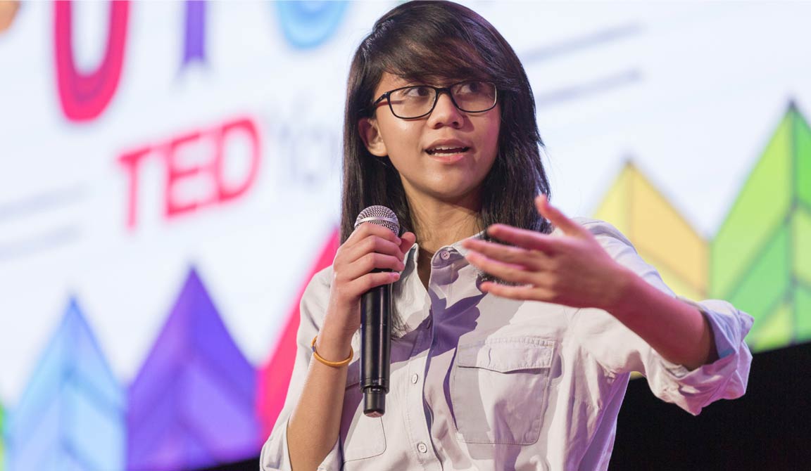 A girl giving a presentation, with outstretched hand