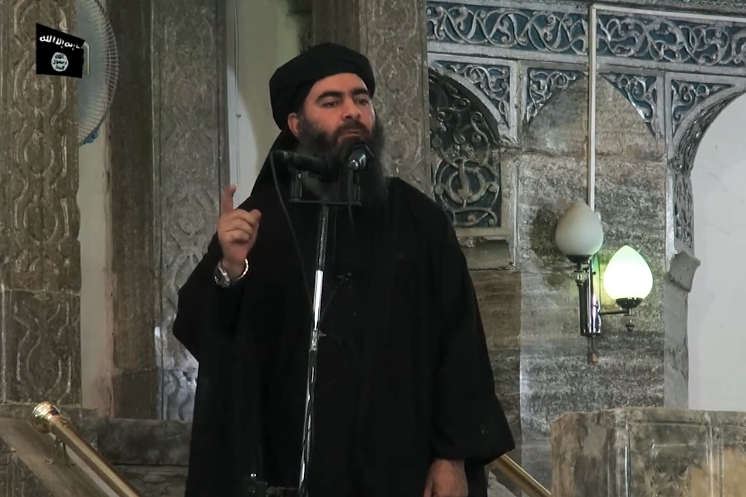 In this file picture taqken on July 5, 2014, an image grab taken from a propaganda video released by al-Furqan Media allegedly shows the leader of the Islamic State (IS) jihadist group, Abu Bakr al-Baghdadi, aka Caliph Ibrahim, adressing Muslim worshippers at a mosque in the militant-held northern Iraqi city of Mosul. (Photo by - / AFP)        (Photo credit should read -/AFP via Getty Images)