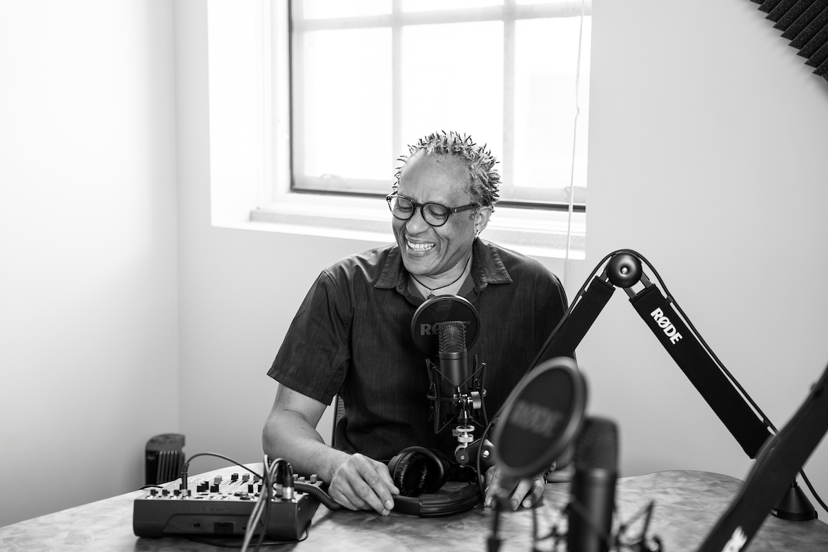 Renard Harris smiling in front of a microphone