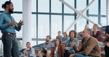 man presenting in front of audience