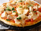 Spicy pizza with chicken, tomatoes, buffalo sauce and cheese