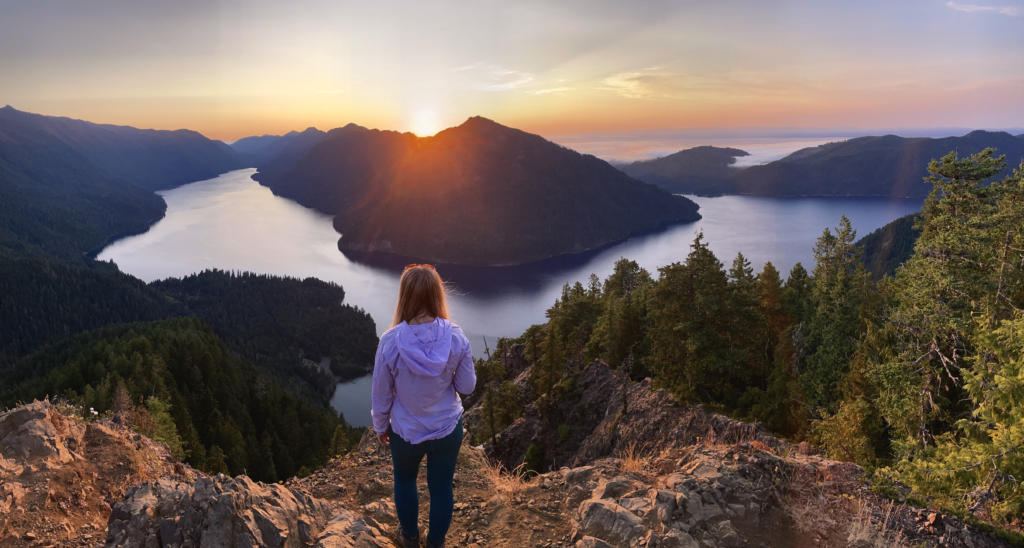 Emily standing at the lookout at Mount Storm King which is a must-see stop on this Washington Road Trip Guide