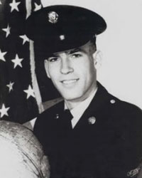 Head shot of a confident-looking young man in an Army uniform.