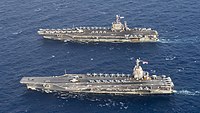 Aerial view of Gerald R. Ford (front) alongside USS Harry S. Truman (back).