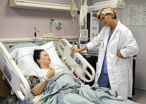 US Navy midwife checks on a mom