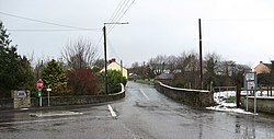 Bridge and road junction in Ballindrait. A monument to the left of the bridge, which crosses the Burn Dale, commemorates The Earl of Tyrone's journey through Ballindrait during the 1607 Flight of the Earls.