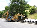 August 12th Case backhoe loader used for pipe transport to an excavated ditch