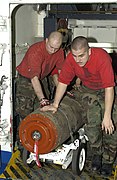 US Navy 030320-N-1397H-006 Aviation Ordnancemen move ordnance out of a weapons elevator to a bomb handling assembly area.jpg