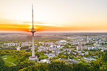 Very tall transmission tower, surrounded by smaller buildings