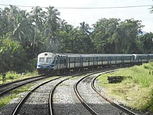 A passenger train rounds a curve