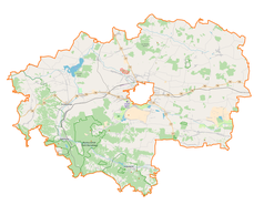Mapa konturowa powiatu zamojskiego, po prawej znajduje się punkt z opisem „Miączyn”