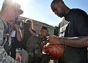 James signs a basketball for an Airman at the 96th Ground Combat Training Squadron (30 September 2010)