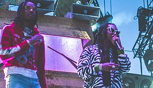 Quavo (left) pictured performing alongside Takeoff (right) as part of Migos, in 2017
