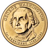 Gold coin with bust of Washington facing slightly left of but looking sternly straight at the viewer. "GEORGE WASHINGTON" is above, "1st PRESIDENT 1789–1797" below, and "JFM" in tiny letters at the bust's base.