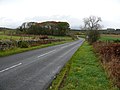 Shennanton. Between two cairns on the B735 road.