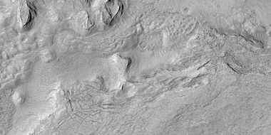 Surface breaking up, as seen by HiRISE under HiWish program. Near the top the surface is eroding into brain terrain.