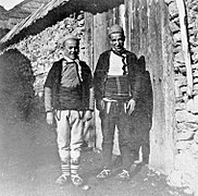 Two young men of Štirovica showing off opingas (shoes).