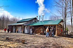 People stand around a shed at a Higley Road farm