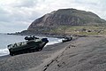 Amphibious Assault Vehicles (AAVs) line the beach below Mount Suribachi on the island of Iwo Jima in a static display for the 58th Anniversary of the Battle of Iwo Jima Commemoration.