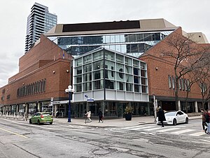 View of the corner of a multistory building with a brick facade