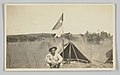 Wilber Rogan smoking a pipe at camp in the Philippines