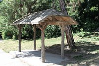 A rain shelter, made of concrete hand sculpted to look like wood, a technique known as faux bois