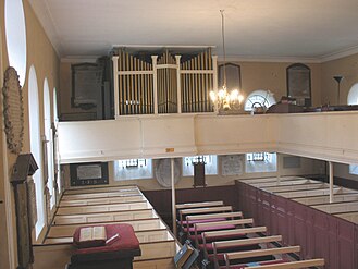 The interior of the church, showing the Georgian box pews and the unusual gallery organ