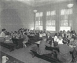 A school cafeteria with students eating