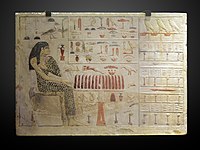 The slab stela of the Old Kingdom Egyptian princess Neferetiabet (dated c. 2590–2565 BC), from her tomb at Giza, with hieroglyphs carved and painted on limestone[1]]]