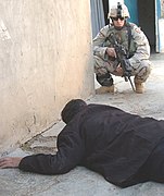 Spc. Thompson watches over a suspected terrorist - DVIDS 2005.jpg