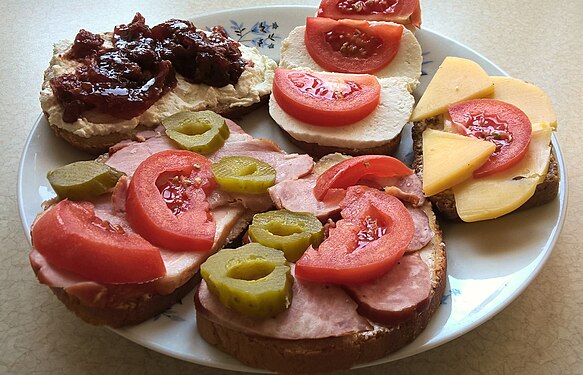 Sandwiches for breakfast - wheat-rye bread with ham and vegetables