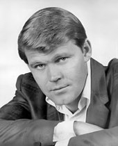 A light-haired man wearing a sport coat