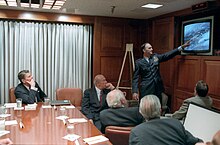 Reagan being briefed by the National Security Council Staff on the 1986 Libya air strike in the White House Situation Room. Seated with Reagan is George Shultz, William Casey, Don Regan, and Charles Gabriel.