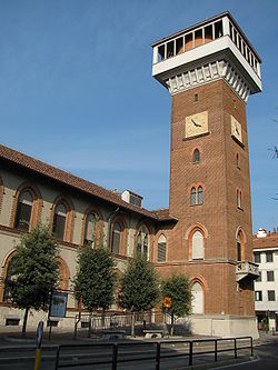 A red brick clock tower and adjacent buildings