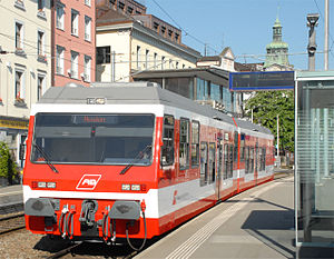 Electric railcar with red and white horizontal stripes