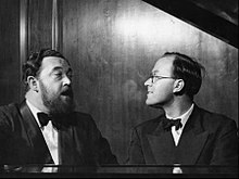 Photo of Flanders and Swann singing at the piano