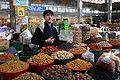 Young Tajikistani boy selling products