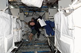 Astronauts Wendy B. Lawrence (foreground) and Andrew S. W. Thomas inside Raffaello MPLM module (STS-114)