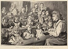 A teacher sits in front of a number of children, many of whom do not appear very attentive.