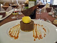 A dessert with a caramel sauce decoration on the plate