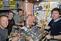 Expedition 20 flight engineers, share a meal at a galley in the Unity node