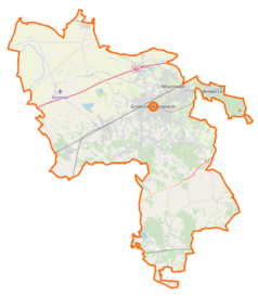 Mapa konturowa powiatu grodziskiego, blisko centrum u góry znajduje się punkt z opisem „Przedsiębiorstwo Komunikacji Samochodowej w Grodzisku Maz.”