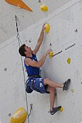 A climber doing the backstepping technique