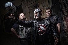 From left to right: John Liebel (guitar), Jon Mikl Thor (vocals), and Ted Andre Jedlicki (bass).