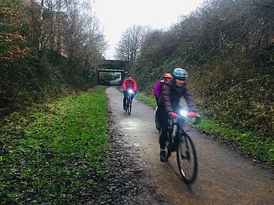 Cyclists in evening on Fallowfield Loop cycle route