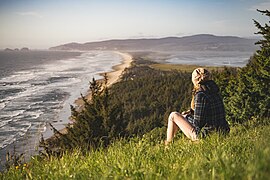 Woman on a slope by the shore (Unsplash).jpg