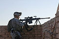 A U.S. Army sniper with Bravo Company, 502nd Infantry Regiment, 101st Airborne Division stands ready to engage targets during a mission on the outskirts of Baghdad, Iraq, Dec. 28, 2005.