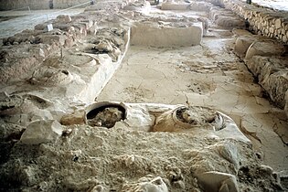 Un almacén con tinajas enterradas en el palacio de Pilos, prueba arqueológica del papel que desempeñaba el palacio en la redistribución de ciertos productos agrícolas.